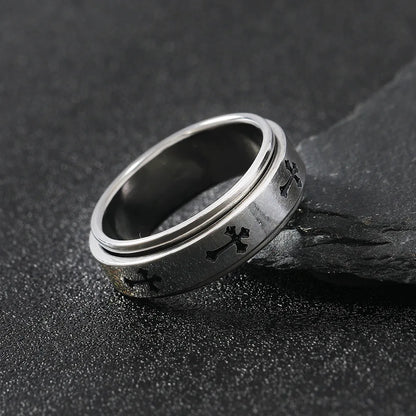 Close up side view of the LuxCrux Rotatable Ring leaning on a piece of stone.